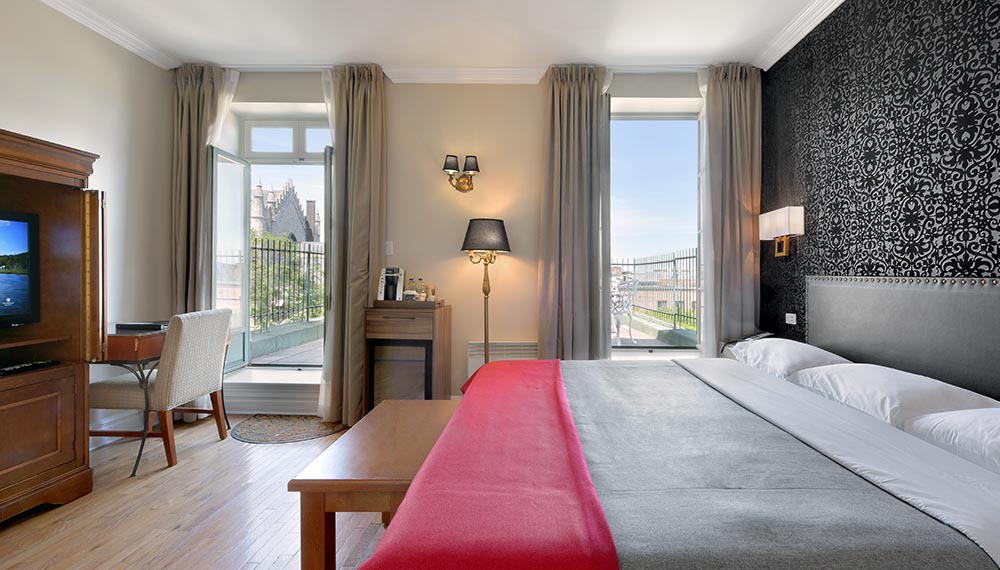 King bed with large private terrace in Old Montreal at Hotel Bonaparte